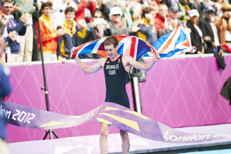 Alistair Brownlee crosses the finish line first, winning gold at the London 2012 Olympics men's triathlon © 2012 - International Olympic Committee (IOC)- HUET, John
